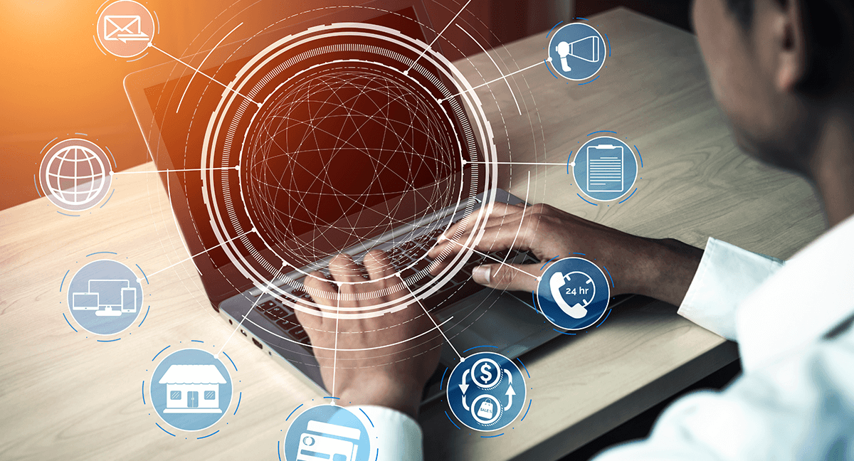 man at computer with multiple communications channels displayed via icons